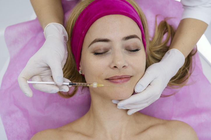 Mature Woman with a doctor aesthetician in beauty hospital